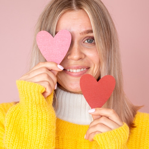 cute woman posing with paper hea