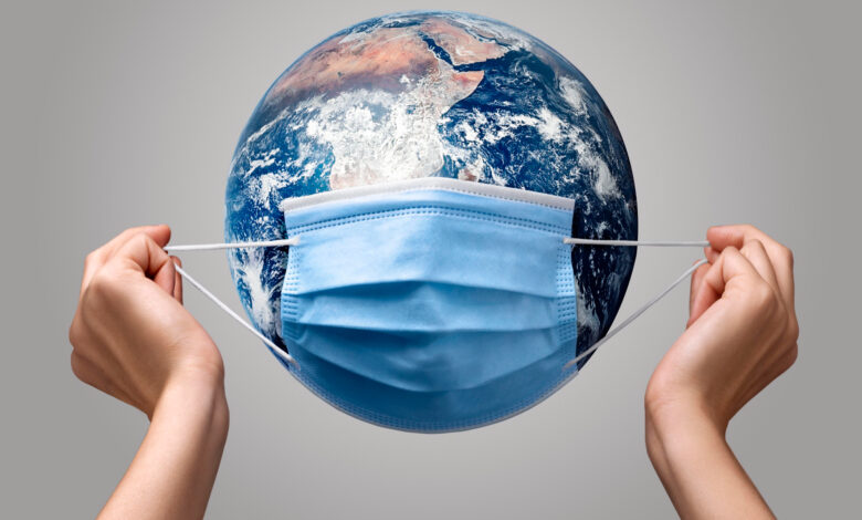 1694778661 person putting medical mask earth